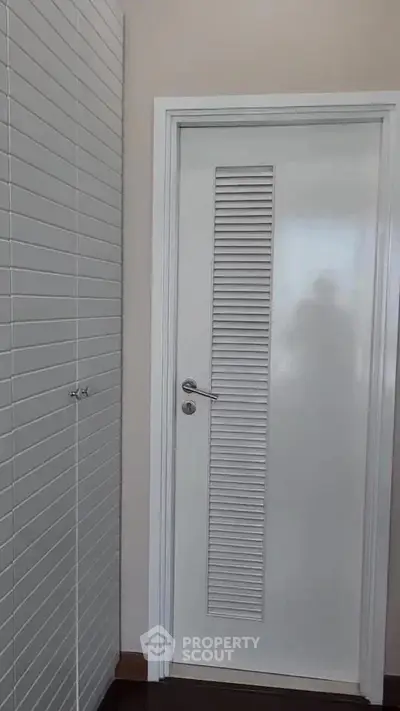 Modern interior door with sleek white paneling and minimalist design in a contemporary home.