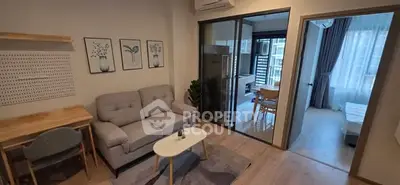 Modern living room with cozy sofa and stylish decor in open-plan apartment