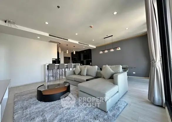 Spacious modern living room with open kitchen and stylish decor