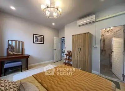 Spacious bedroom with elegant decor and ensuite bathroom in modern home