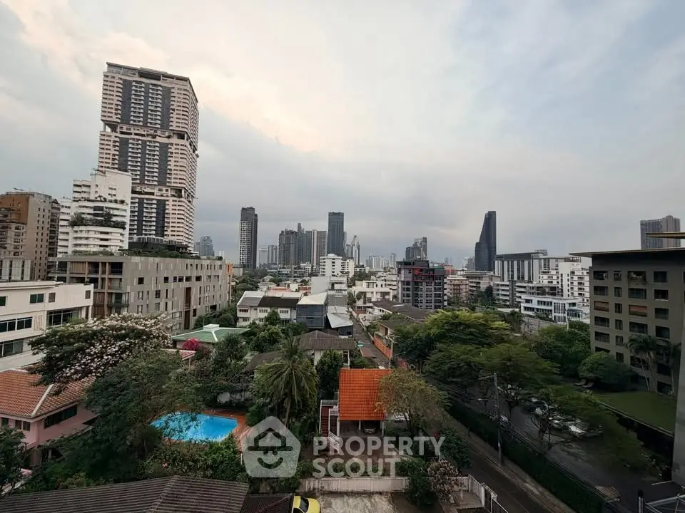 Stunning cityscape view with modern high-rise buildings and lush greenery, perfect for urban living.