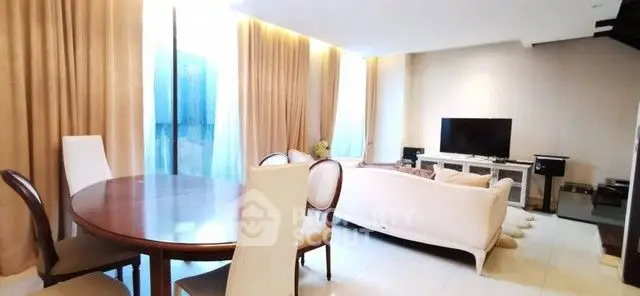 Spacious living room with elegant dining area and modern entertainment setup.