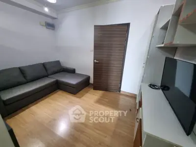 Cozy living room with modern sofa and sleek TV unit, perfect for relaxation.