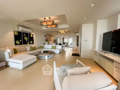 Spacious modern living room with elegant decor and large sectional sofa, perfect for entertaining.