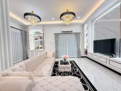 Luxurious living room with elegant chandeliers and plush seating in a modern home.