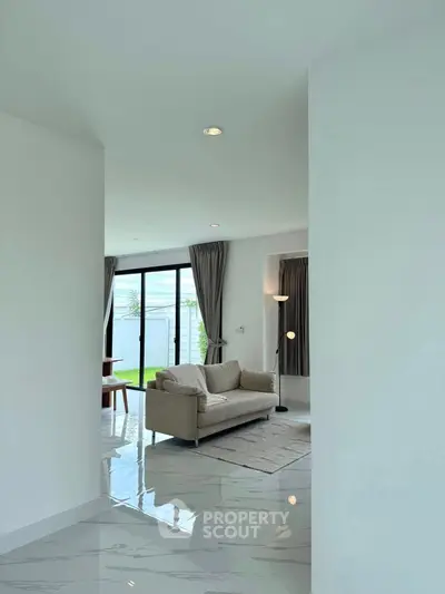 Modern living room with sleek design and large windows offering garden view