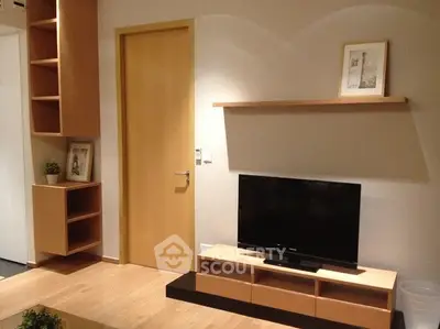 Modern living room with sleek wooden furniture and flat-screen TV