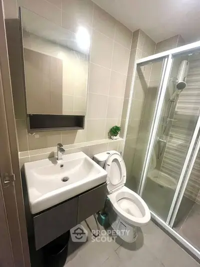 Modern bathroom with sleek fixtures and glass shower enclosure