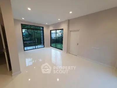 Spacious modern living room with large windows and garden view