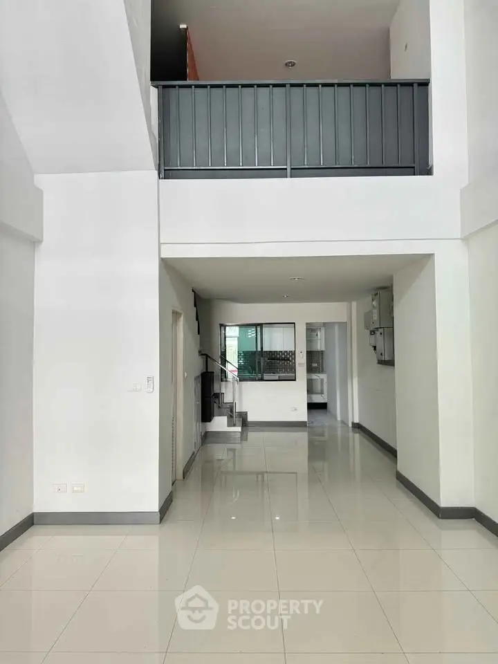 Spacious modern interior with high ceilings and sleek design, perfect for contemporary living.