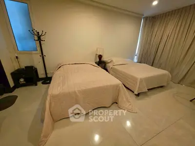 Spacious bedroom with twin beds and elegant decor