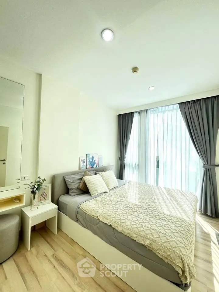 Bright and cozy bedroom with large window and modern decor