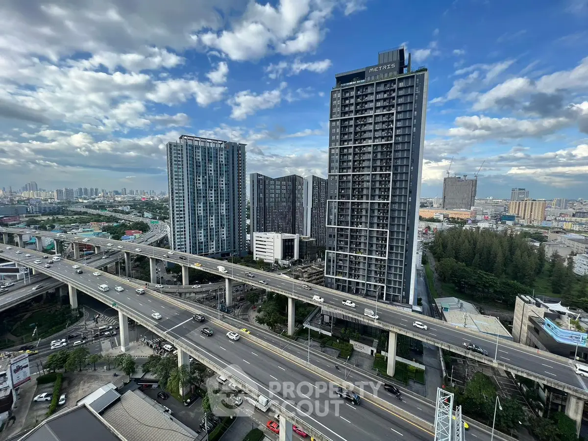 Stunning high-rise buildings with urban skyline and highway view, perfect for modern city living.