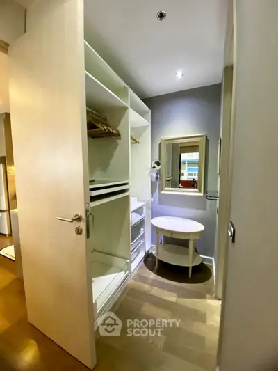 Spacious walk-in closet with modern shelving and elegant lighting