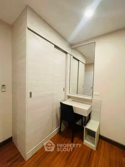 Modern bedroom with built-in wardrobe and sleek vanity desk