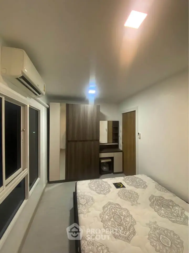 Modern bedroom with air conditioning and stylish decor in a cozy apartment.