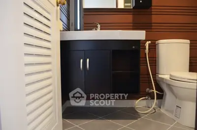 Modern bathroom with sleek fixtures and wooden paneling
