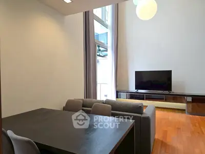 Modern living room with high ceiling and sleek furniture