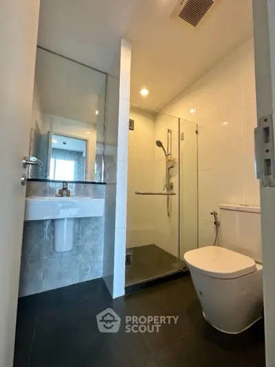 Modern bathroom with glass shower and sleek fixtures