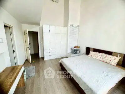 Spacious bedroom with modern design and ample natural light