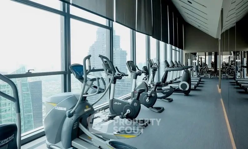 Spacious modern gym with panoramic city views and state-of-the-art equipment.