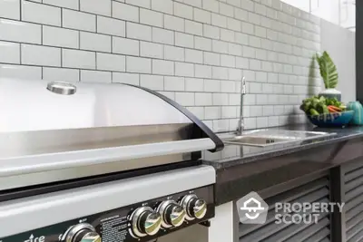 Modern outdoor kitchen with sleek grill and stylish backsplash