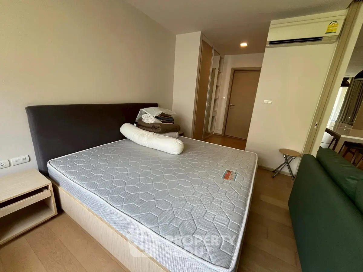 Spacious bedroom with modern furnishings and air conditioning in a stylish apartment.