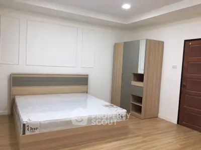 Spacious bedroom with modern wooden furniture and cozy lighting