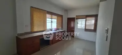 Spacious room with large windows and wooden blinds, ideal for versatile use.