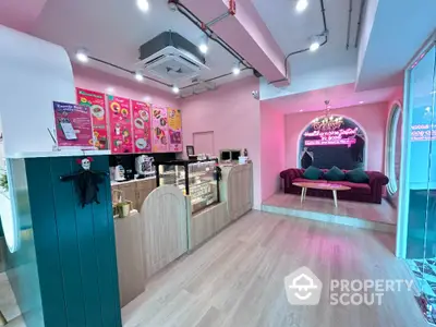 Charming pink-themed cafe interior with cozy seating and modern decor