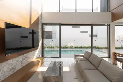 Luxurious modern living room with pool view and elegant decor