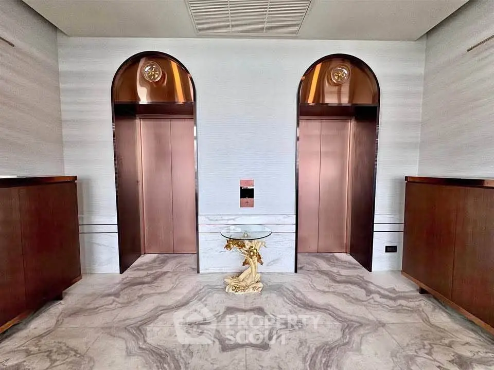 Luxurious building lobby with elegant elevators and marble flooring