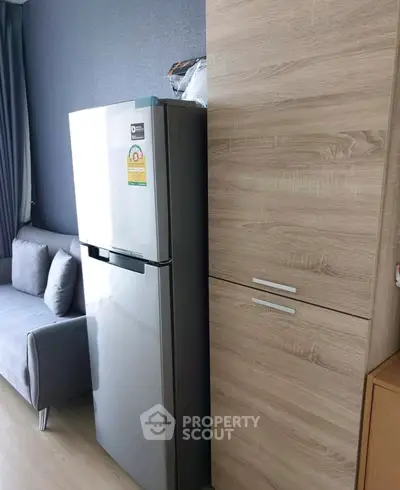 Modern apartment interior with sleek fridge and stylish sofa