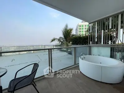 Luxurious balcony with bathtub and stunning city view, perfect for relaxation and enjoying the skyline.