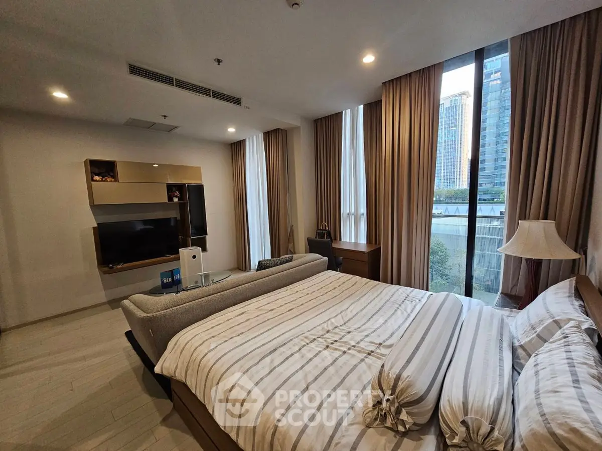 Luxurious bedroom with modern decor and city view, featuring a cozy bed and stylish furniture.