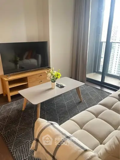 Modern living room with stylish furniture and large window view