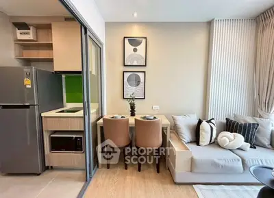 Modern open-plan living room with cozy seating and compact kitchen area