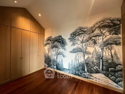 Spacious bedroom with artistic wall mural and wooden flooring