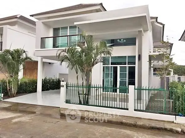 Modern two-story house with sleek design and spacious driveway in a serene neighborhood.