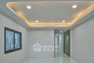 Modern minimalist interior with recessed lighting and sleek design