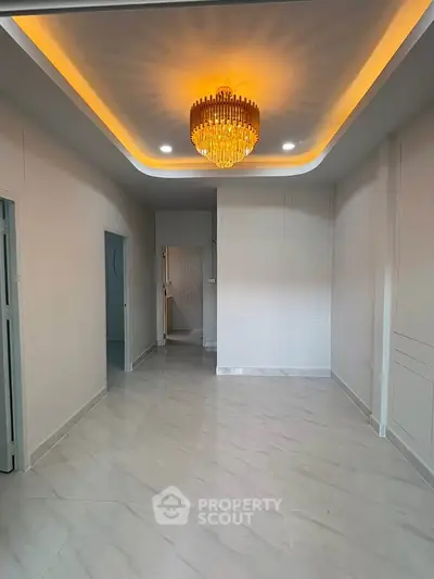 Elegant interior with modern chandelier and marble flooring