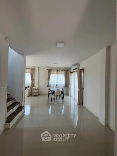 Spacious modern living room with elegant dining area and natural light