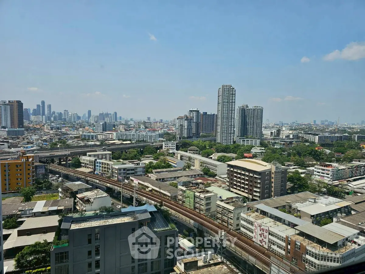 Stunning cityscape view showcasing urban skyline and residential buildings under a clear blue sky.