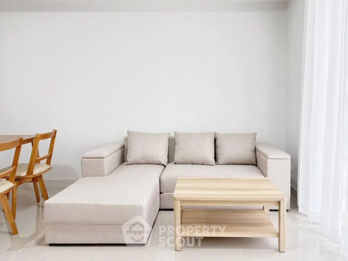 Modern living room with stylish beige sofa and wooden coffee table