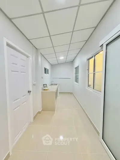 Modern kitchen with sleek countertops and ample natural light, perfect for culinary enthusiasts.