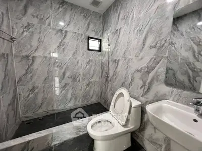 Modern bathroom with elegant marble tiles and sleek fixtures