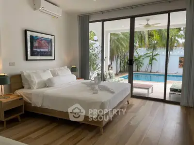 Luxurious bedroom with pool view, modern decor, and elegant furnishings for a serene living experience.