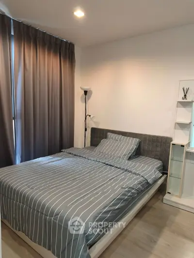 Cozy bedroom with modern decor and ample natural light