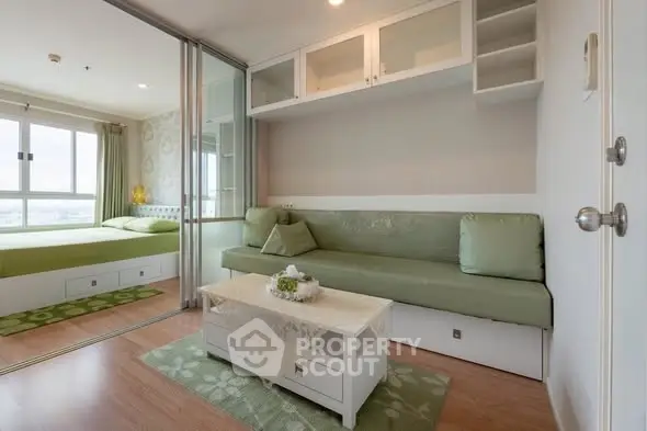 Modern studio apartment with sliding glass doors and stylish green decor.