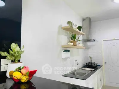 Modern kitchen with sleek design, featuring white cabinets, open shelves, and a gas stove for a stylish cooking space.